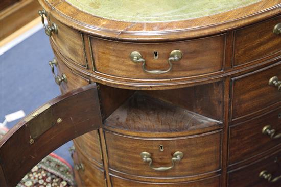 A George III mahogany oval pedestal partners desk, W.4ft 11in. D.3ft 1in. H.2ft 7in.